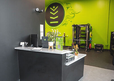 Redmond clinic front desk with physical therapy room partially in the background