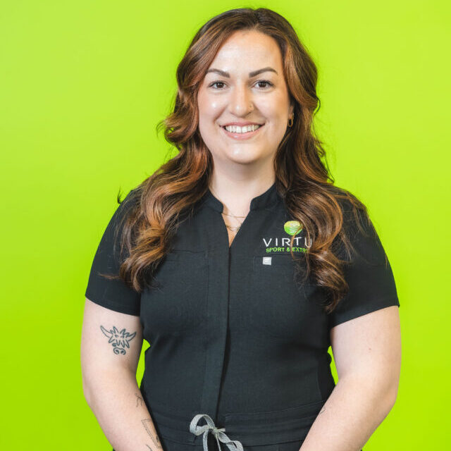 cary-claeys-2026 Cary Claeys smiling wearing black Virtus scrubs, professional portrait