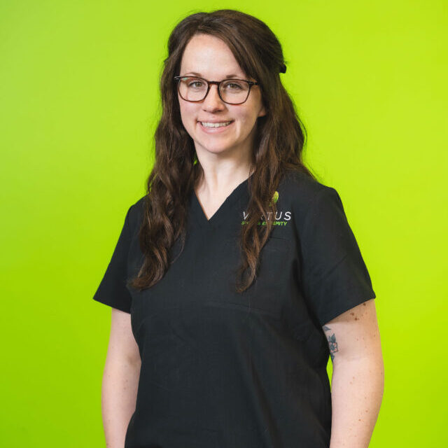 morgan-mccoy-2026 Morgan McCoy smiling wearing black Virtus scrubs, professional portrait