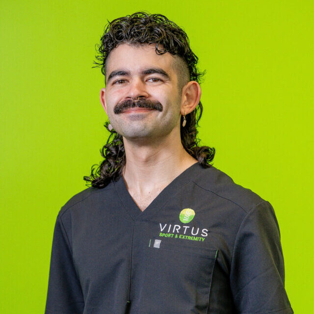 cole-shimabukuro-2026 Cole Shimabukuro smiling wearing black Virtus scrubs, professional portrait