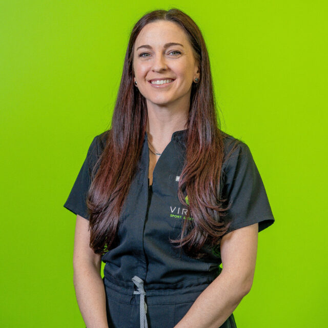molly-sparks-2026 Dr. Molly Sparks, smiling wearing black Virtus scrubs, professional portrait