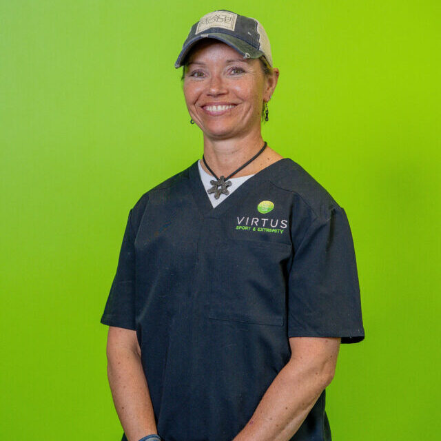 kerry-mrachek-2026 Kerry Mrachek smiling wearing black Virtus scrubs, professional portrait