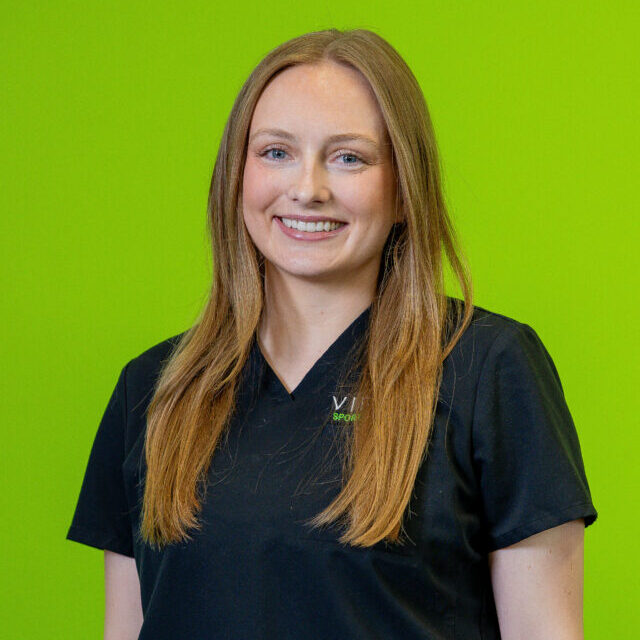 malia-wienstroer-2026 Malia Wienstroer smiling wearing black Virtus scrubs, professional portrait
